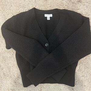 Woman’s black button-down sweater